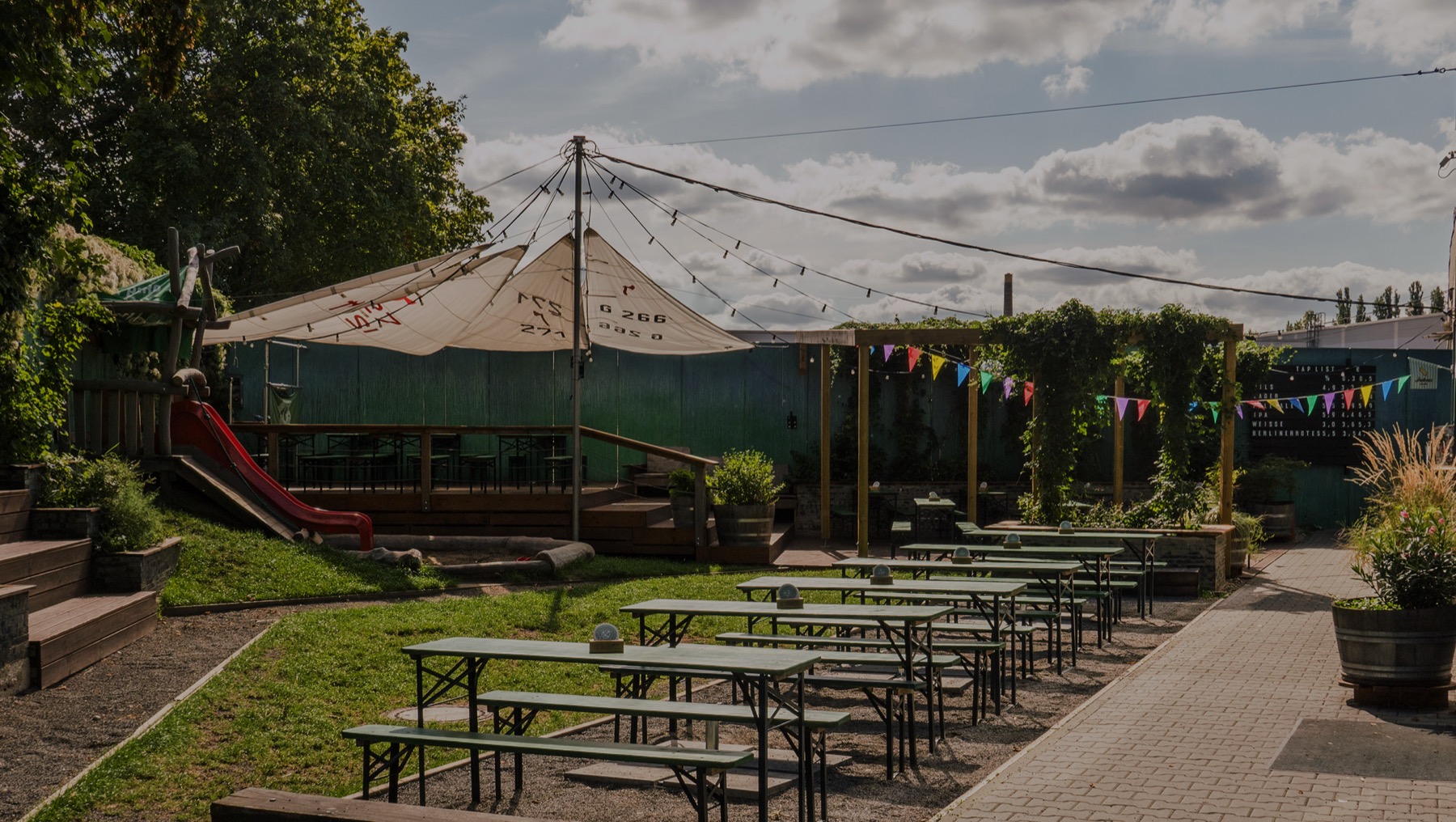 Berliner Berg Brauerei beer garden — bunting flags and picnic tables